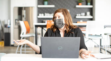 Woman wearing Aries Barrier Face Covering, face mask, charcoal gray